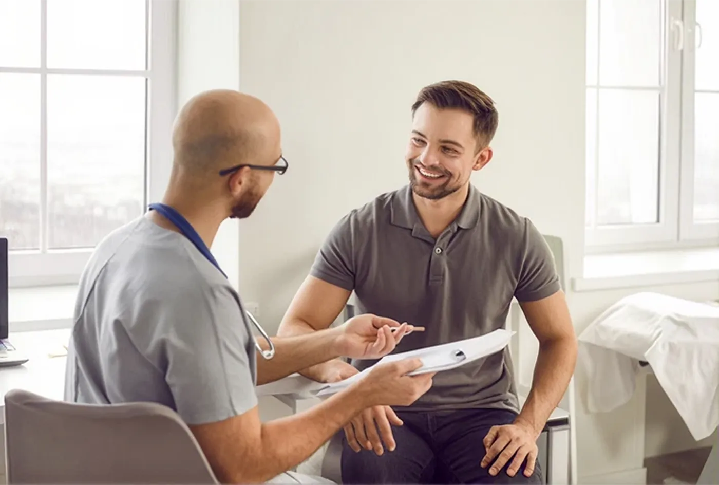 A hair transplant patient reviewing his aftercare with his clinician