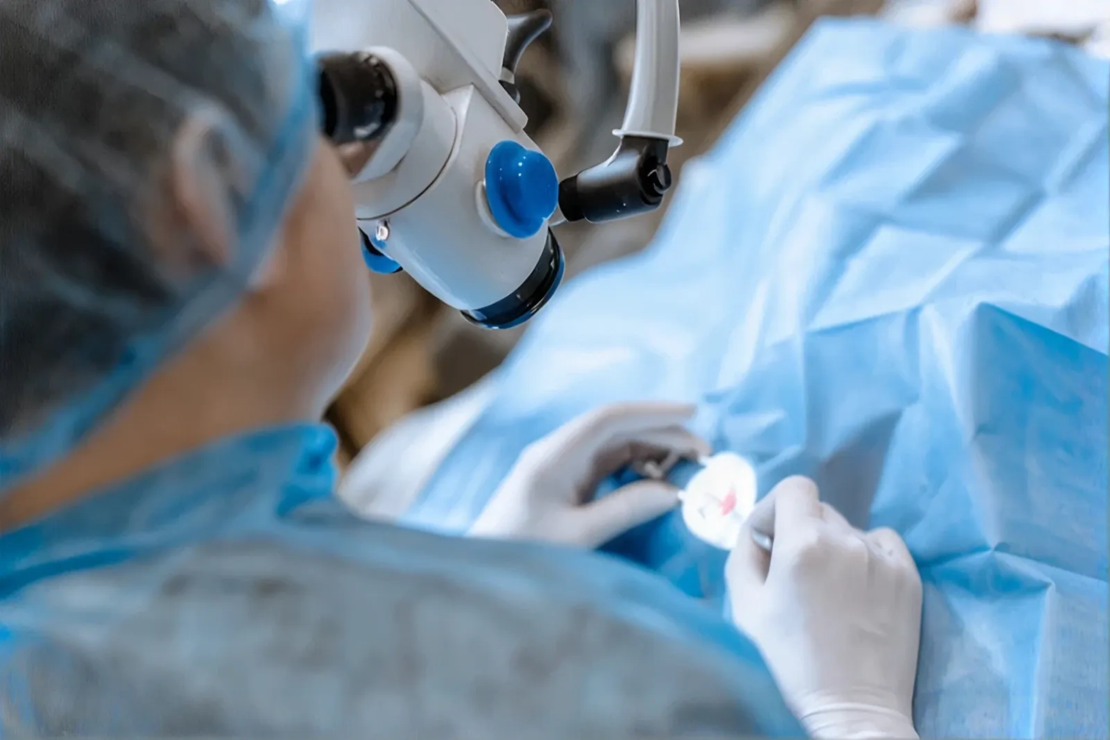 Ophthalmic surgeon operating under a surgical microscope